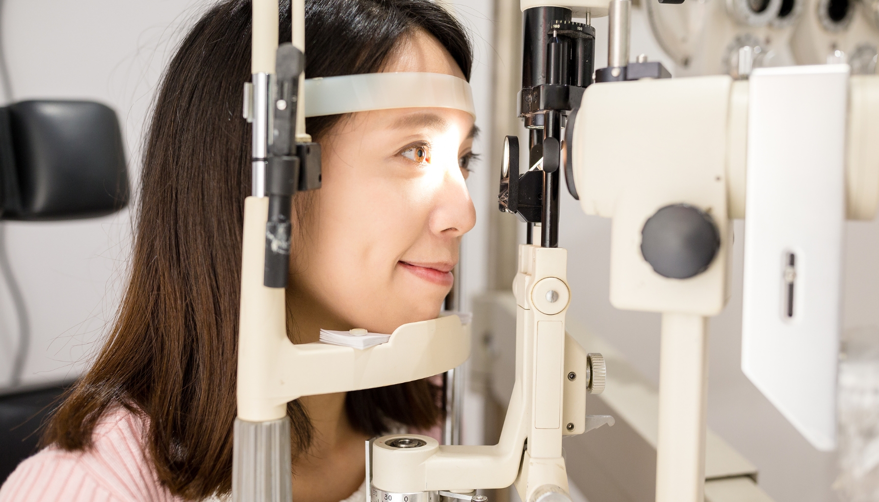 Photo of patient getting her improved vision checked after ICL surgery