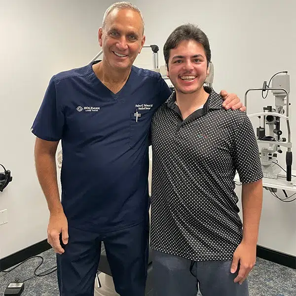 A happy patient smiling in an exam room