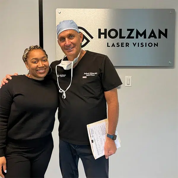 Eye doctor examining a patient's eyes using a slit lamp at Holzman Laser Vision clinic